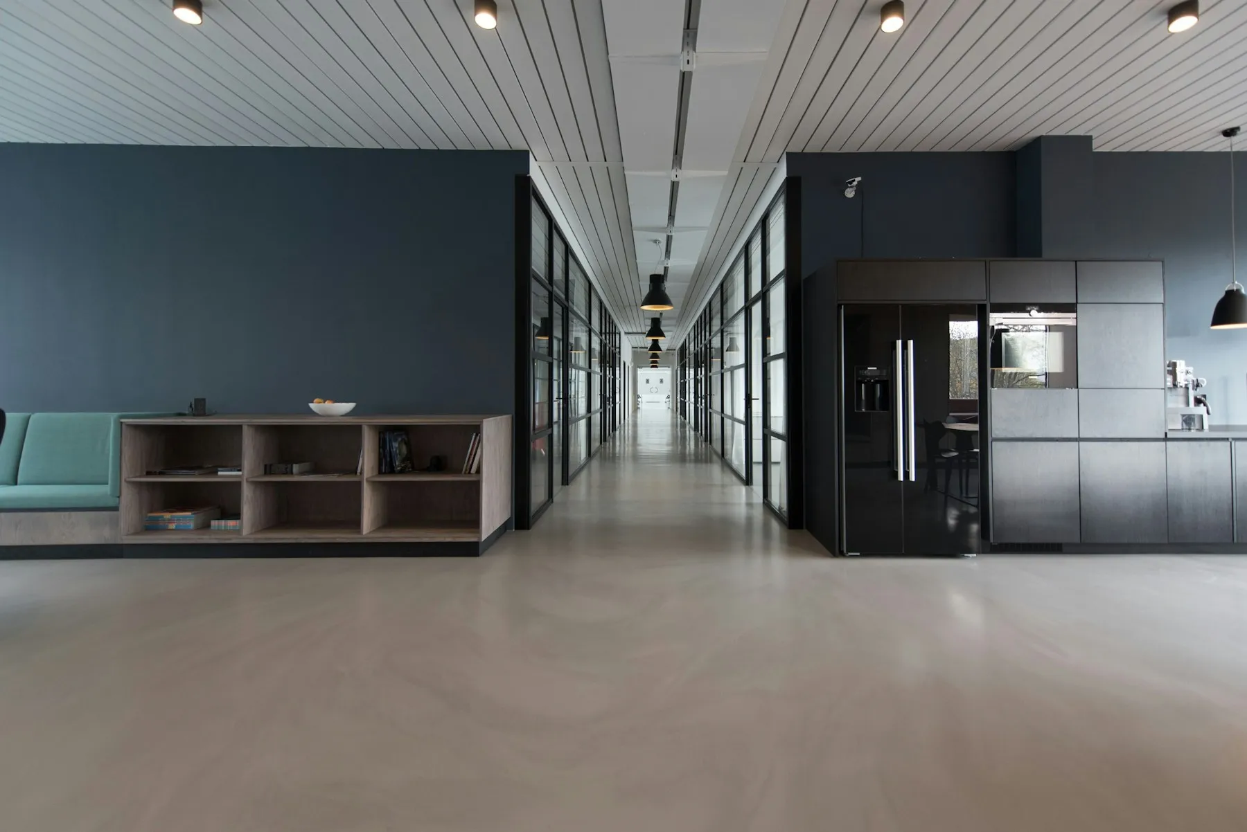 Clean, empty office corridor with glass partitions