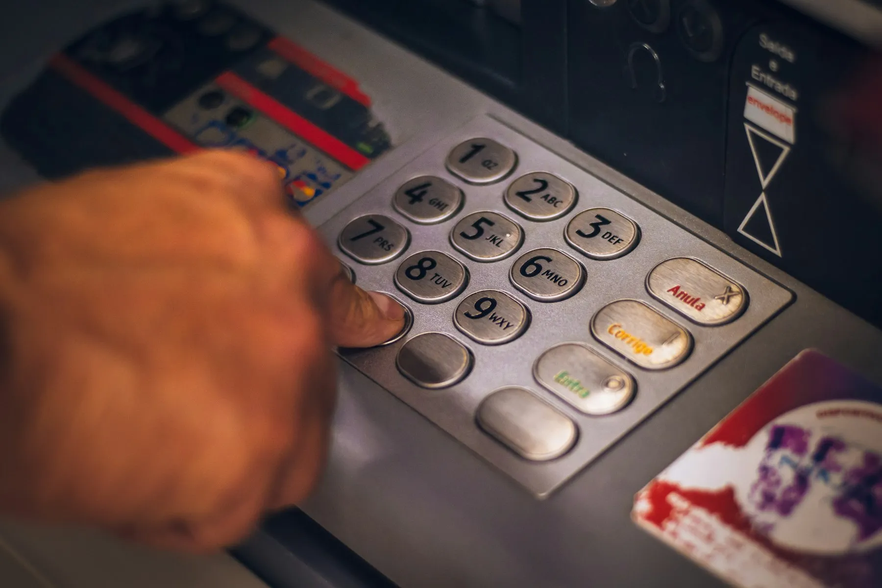 Hand entering a code on a keypad access terminal